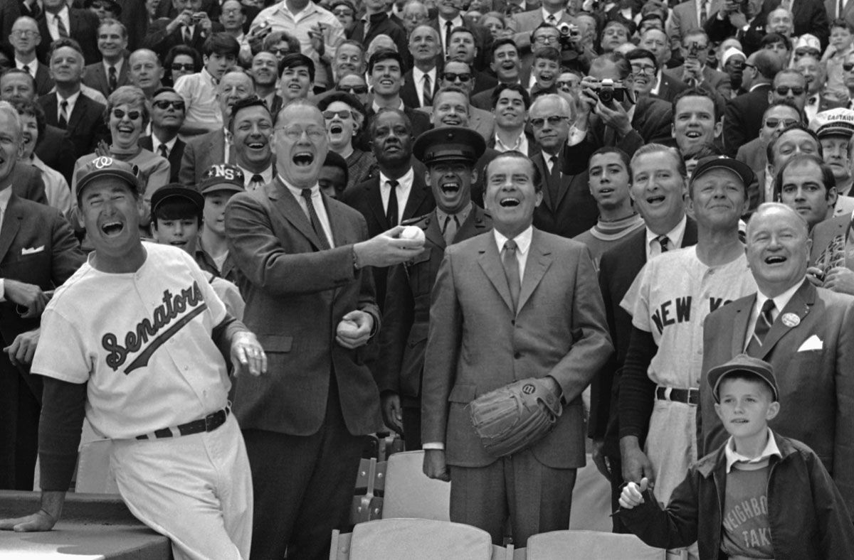 President  Richard  Nixon and Baseball Commissioner Bowie Kuhn, center-left, join Washington Senators manager Ted Williams, left, in a round of laughter before the chief  executive tossed out the first ball in opening game at RFK Stadium in Washington, April 7, 1969. Laughs were scarce later among Washington fans as the New York Yankees defeated the Senators 8-4. (AP Photo)