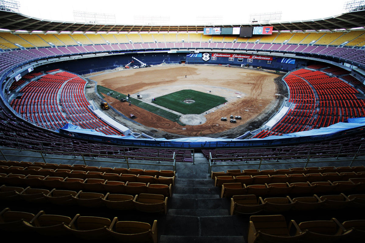 The Washington Nationals' home field, the RFK Memorial Stadium, is seen from the upper bleachers behind the home plate, as workers lay the turf, Monday, March 14, 2005, in Washington. The playing field will have 111,000 square feet of sand-based hybrid Bermuda grass over-seeded with perennial rye grass. (AP Photo/Manuel Balce Ceneta)