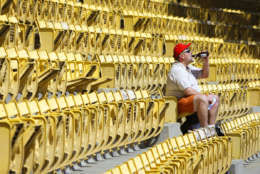 Carl G. Evans, from Warrenton, Va., drinks his beer as he sits in the upper deck section of RFK Stadium before the start of the baseball game between the Atlanta Braves and the Washington Nationals, Sunday Sept. 16, 2007 at RFK Stadium in Washington. The Washington Nationals are entering their final home stand at RFK Stadium, which opened in 1962 in the nation's capital. The stadium has also been home to the Washington Senators, the NFL's Washington Redskins, and the MLS DC United Soccer team. The Nationals are moving to a new $611 million ballpark, located in Southeastern Washington along the Anacostia River for opening day in April, 2008. (AP Photo/Pablo Martinez Monsivais)