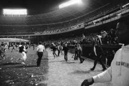 Washington Senators fans storm the field, stopping the game in the ninth inning, between the Yankees and the Senator, in Washington, Oct. 1, 1971. Fans' actions caused the Senators to forfeit the game to the Yankees. (AP Photo/Jim Palmer)