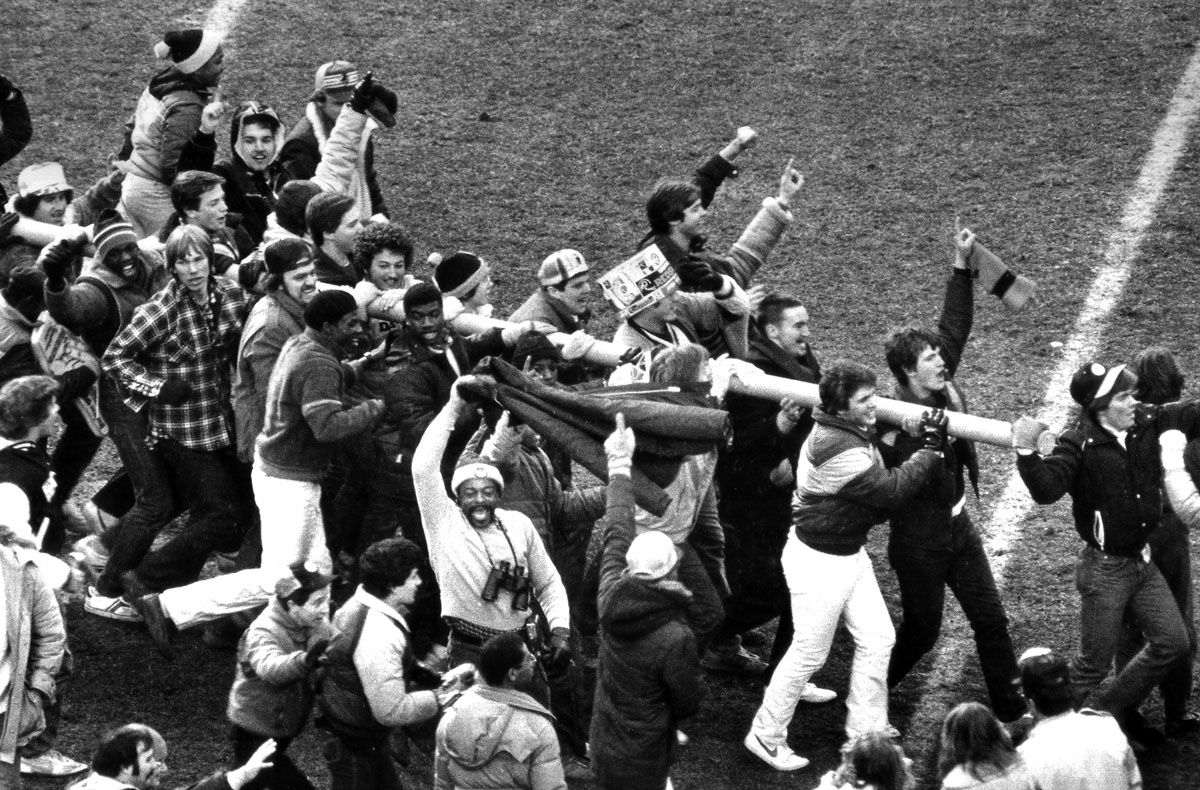 Washington Redskins fans carry a piece of the goal post off the field after their team defeated the Dallas Cowboys 31-17 for the NFC championship in Washington, earning a trip to the Super Bowl, Jan. 22, 1983. (AP Photo)
