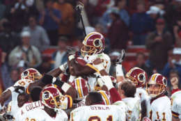 Washington Redskins wide receiver Art Monk is hoisted by his teammates after breaking the record for career receptions in the fourth quarter of their game against the Denver Broncos at RFK Stadium in Washington, Oct. 12, 1992.  (AP Photo/Wilfredo Lee)