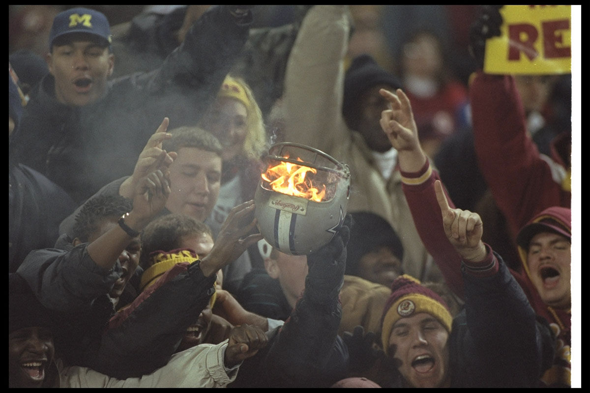 22 Dec 1996:  Washington Redskins fans set fire to a Dallas Cowboys helmet during a game at RFK Stadium in Washington, D. C.  The Redskins won the game, 37-7. Mandatory Credit: Doug Pensinger  /Allsport