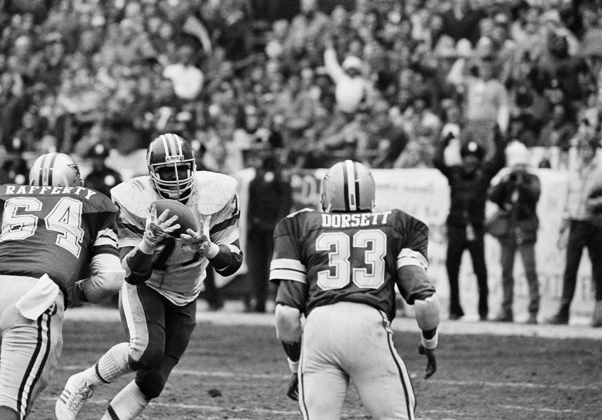 Washington Redskins defensive tackle Darryl Grant catches a deflected Dallas Cowboys Gary Hogeboom pass and high steps it into the end zone in Washington, on Jan. 24, 1983. The Redskins defeated the Cowboys 31-17 to become the NFC champions and advance to the Superbowl where they will meet the Miami Dolphins. (AP Photo)
