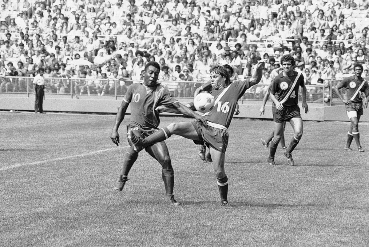 Brazilian soccer star Pele (10) who plays for the New York Cosmos, battles Washington Diplomats? Roy Willner for the ball during game in Washington on Sunday, June 29, 1975. Pele led the Cosmos to a 9 to 2 victory. (AP Photo/Harvey Georges)