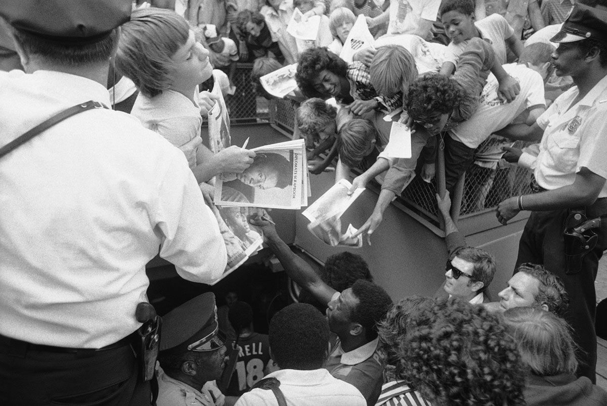Pele, known as ?The King? of soccer, signs autographs after leading the New York Cosmos to a 9-2 win over the Washington Diplomats, in Washington on Sunday, June 30, 1975. A record crowd of 35,620, for a North American Soccer League game, was on hand. (AP Photo/Harvey Georges)