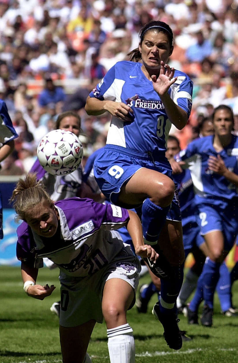 Washington Freedom's Mia Hamm (9) battles for the ball with Ann Cook of the Bay Area CyberRays during the first half of the inaugural WUSA Soccer match at RFK Stadium in Washington, Saturday, April 14, 2001(AP Photo/Alex Brandon)