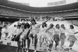 Washington area high school girls, recruited to help set up the stage for the Beach Boys, take to dancing as the Beach Boys perform their opening number at RFK Stadium in Washingto, June 12, 1983. The Beach Boys held their concert after the Team America-Ft. Lauderdale Strikers soccer game. (AP Photo/Ira Schwarz)