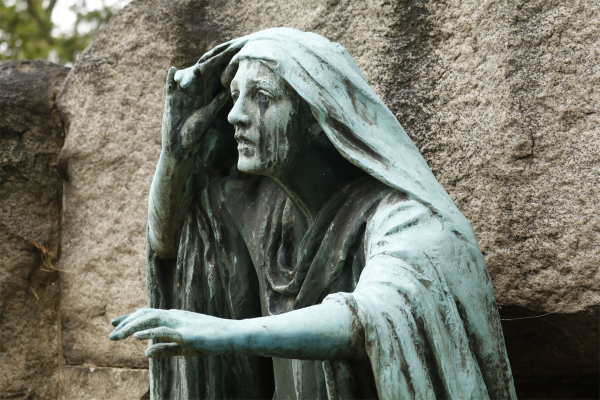 Rock Creek Cemetery is the site of some "master sculptures," said Anne Brockett, an archictectural historian in the D.C. Office of Historic Preservation. This sculpture called Rabboni depicts the moment Mary Magdalene emerged from Jesus' tomb to discover he had arisen. The sculpture was designed by artist Gutzon Borglum for a prominent D.C. banker. Borglum also famously designed Mount Rushmore.  (WTOP/Kate Ryan)
