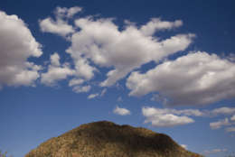 Clouds hover over a mountain Wednesday, March 30, 2016, in Scottsdale, Ariz. (AP Photo/Jae C. Hong)