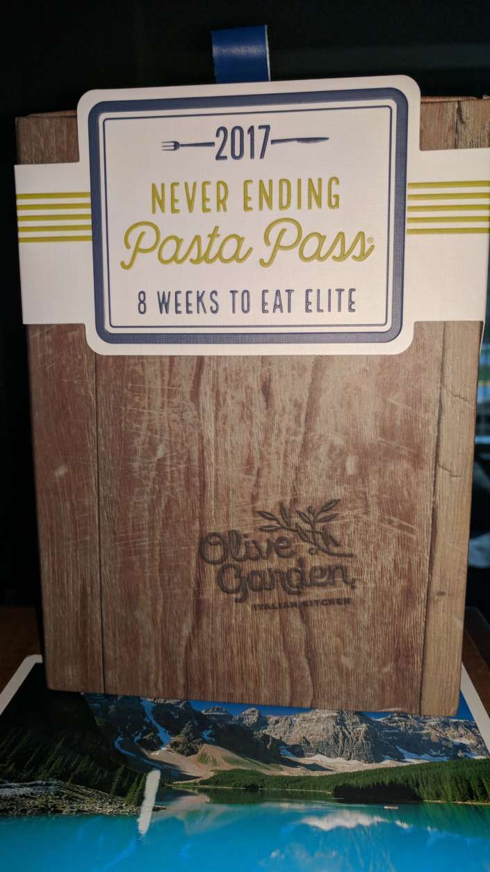 WTOP's Brandon Millman receives his Never Ending Pasta Pass from Olive Garden. (WTOP/Brandon Millman)