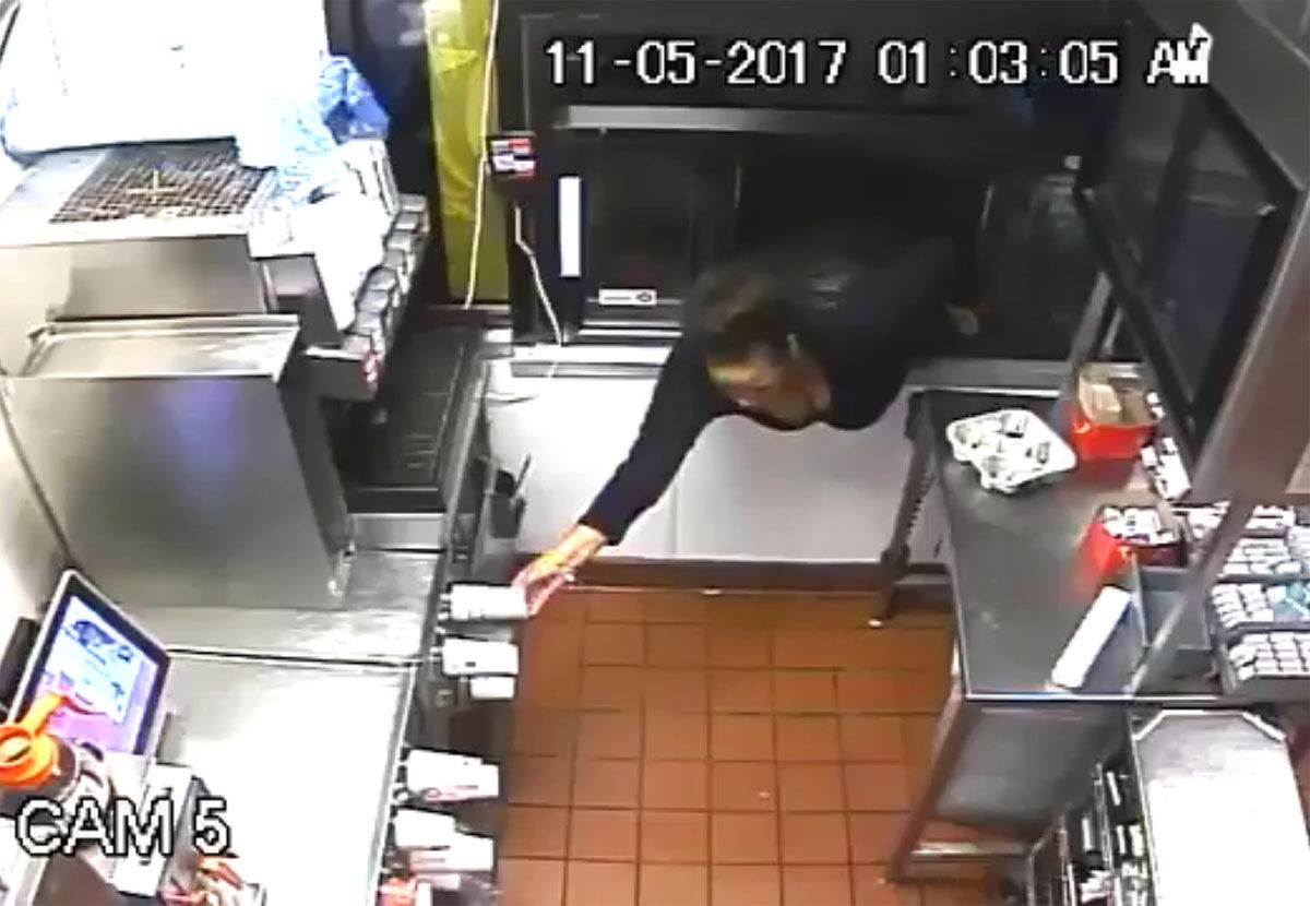 Howard County Police said they're looking for a woman who was caught on surveillance video climbing through a McDonald's drive-thru window in Columbia, Maryland earlier this month, to steal food and cash. (Courtesy Howard County Police Department)