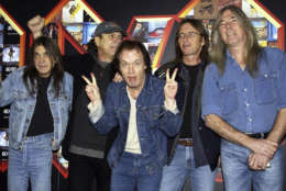 FILE -  A March 3, 2003 file photo of from left: Malcolm Young, Brian Johnson, Angus Young, Phil Rudd and Cliff Williams from AC/DC posing for photographers at the Apollo Hammersmith in London. The band has announced, Saturday Nov. 18, 2017,  that 64-year-old Young has died. (Yui Mok/PA via AP)
