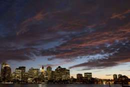 The sunset illuminates clouds over Boston harbor and the city skyline Monday, Oct. 5, 2015 in Boston. (AP Photo/Michael Dwyer)