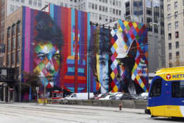 A mural of folk-rock legend and Minnesota native Bob Dylan by Brazilian artist Eduardo Kobra and his team of five artists adorns the wall of a building, Friday, Sept. 11, 2015, in downtown Minneapolis. The mural was commissioned by the building's owner, Goldman Sachs, in an effort to help Minneapolis revitalize the area. (AP Photo/Jim Mone)
