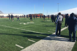 D.C.'s H.D. Woodson High School football team warms up for the 2017 Turkey Bolw. The team was down 17 players who were suspended for their involvement in a brawl during a recent game. (WTOP/Mike Murillo)