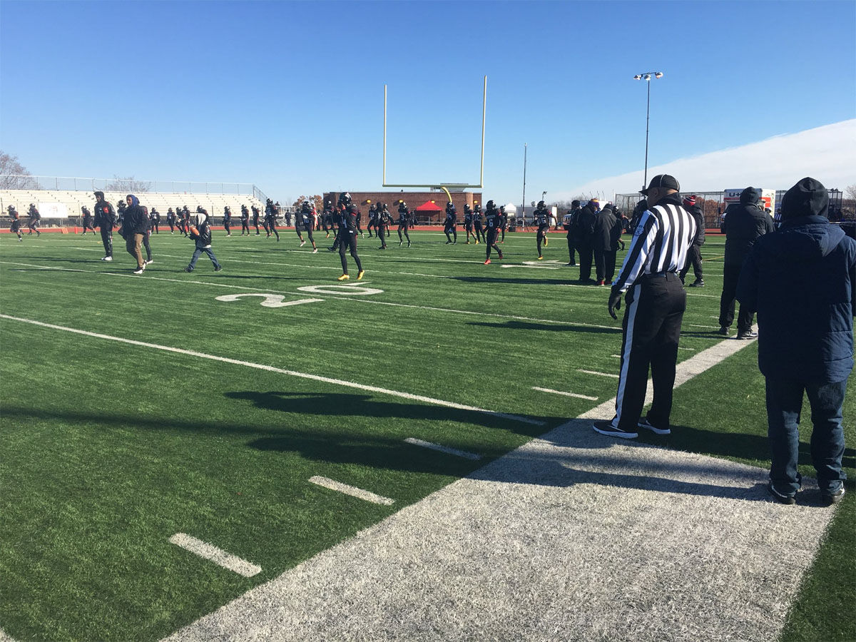 D.C.'s H.D. Woodson High School football team warms up for the 2017 Turkey Bolw. The team was down 17 players who were suspended for their involvement in a brawl during a recent game. (WTOP/Mike Murillo)