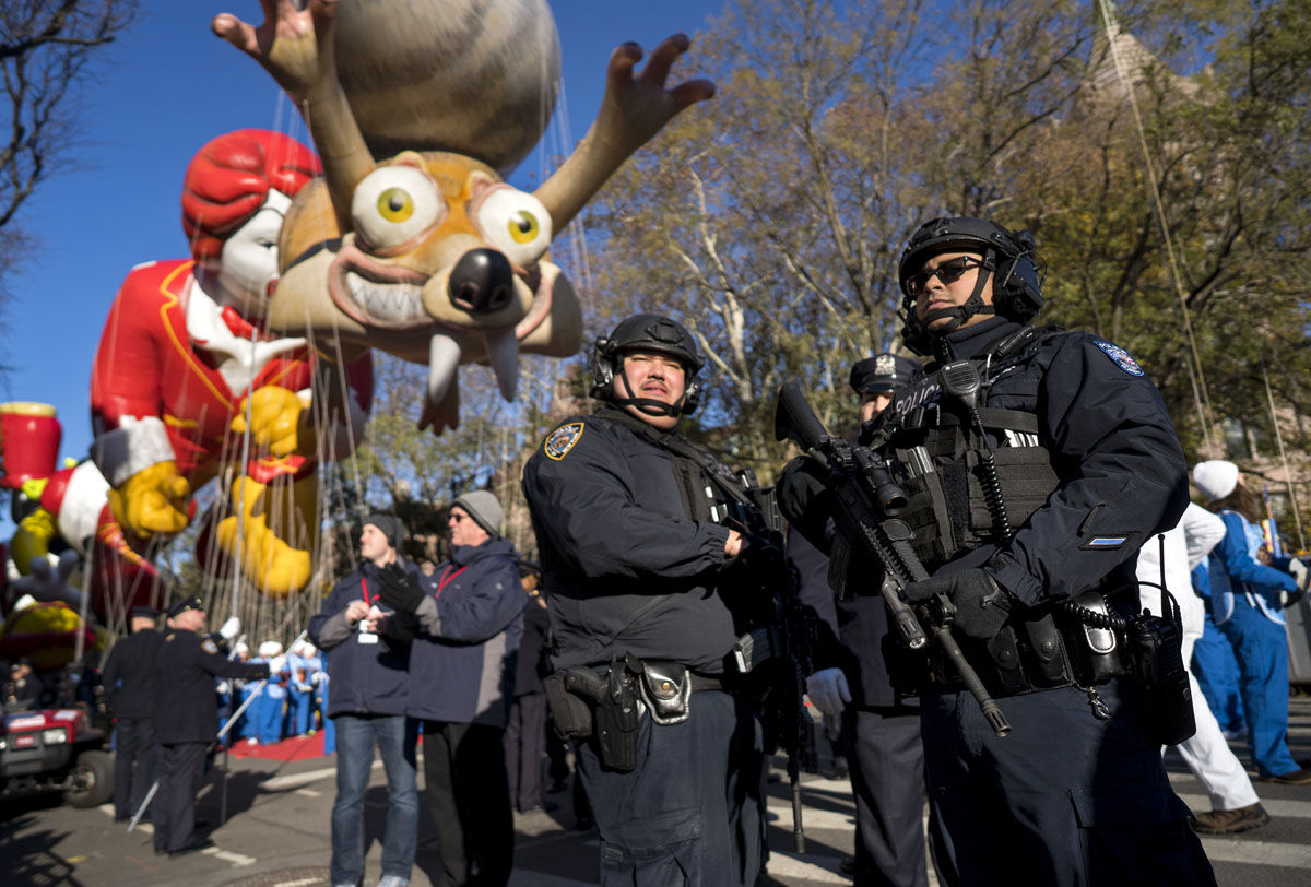 Heavily-armed members of the New York Police Department take a position along the route before the start of the Macy's Thanksgiving Day Parade in New York, Thursday, Nov. 23, 2017. (AP Photo/Craig Ruttle)