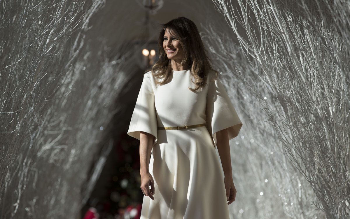 First lady Melania Trump walks along the East Colonnade decorated in white branches that are part of 2017 holiday decorations with the theme "Time-Honored Traditions" at the White House in Washington, Monday, Nov. 27, 2017.  (AP Photo/Carolyn Kaster)