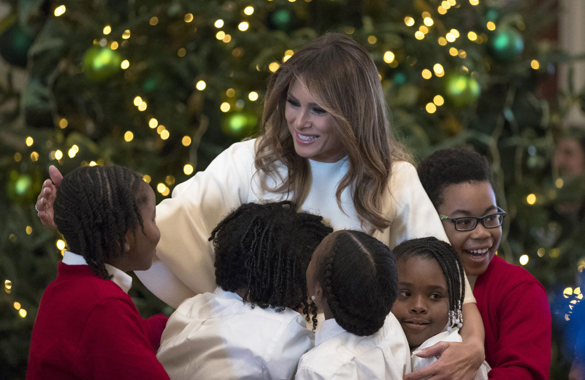 First lady Melania Trump is greeted by children as she arrives to visits with them in the East Room among the 2017 holiday decorations with the theme "Time-Honored Traditions" at the White House in Washington, Monday, Nov. 27, 2017. The First Lady honored 200 years of holiday traditions at the White House. (AP Photo/Carolyn Kaster)
