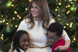 First lady Melania Trump is greeted by children as she arrives to visits with them in the East Room among the 2017 holiday decorations with the theme "Time-Honored Traditions" at the White House in Washington, Monday, Nov. 27, 2017. The First Lady honored 200 years of holiday traditions at the White House. (AP Photo/Carolyn Kaster)