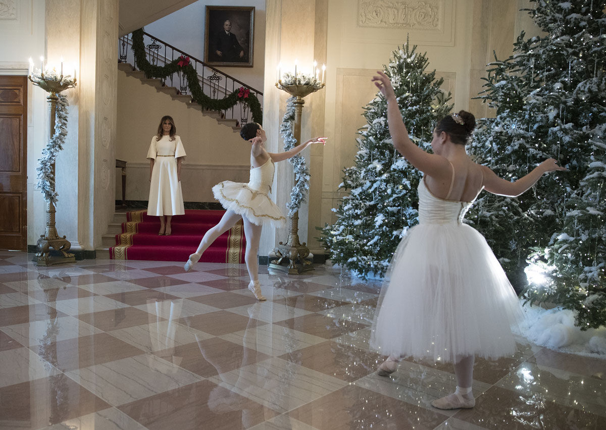 First lady Melania Trump watches a ballerinas perform a piece from The Nutcracker among the 2017 holiday decorations in the Grand Foyer of the White House in Washington, Monday, Nov. 27, 2017. The First Lady honored 200 years of holiday traditions at the White House. (AP Photo/Carolyn Kaster)