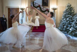 First lady Melania Trump watches as ballerinas perform a piece from The Nutcracker among the 2017 holiday decorations in the Grand Foyer of the White House in Washington, Monday, Nov. 27, 2017. The First Lady honored 200 years of holiday traditions at the White House. (AP Photo/Carolyn Kaster)