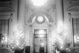 What with the lighted Christmas trees in front of its portals in Washington on Dec. 25, 1931, the White House presented a beautiful, softly illuminated spectacles on Christmas night, and one at once sensed the serenity and joyous festivity of the day that prevailed behind the closed doors, where the grandchildren of President and Mrs. Hoover, Peggy Ann and Herbert, made merry with their toys and gifts. (AP Photo)