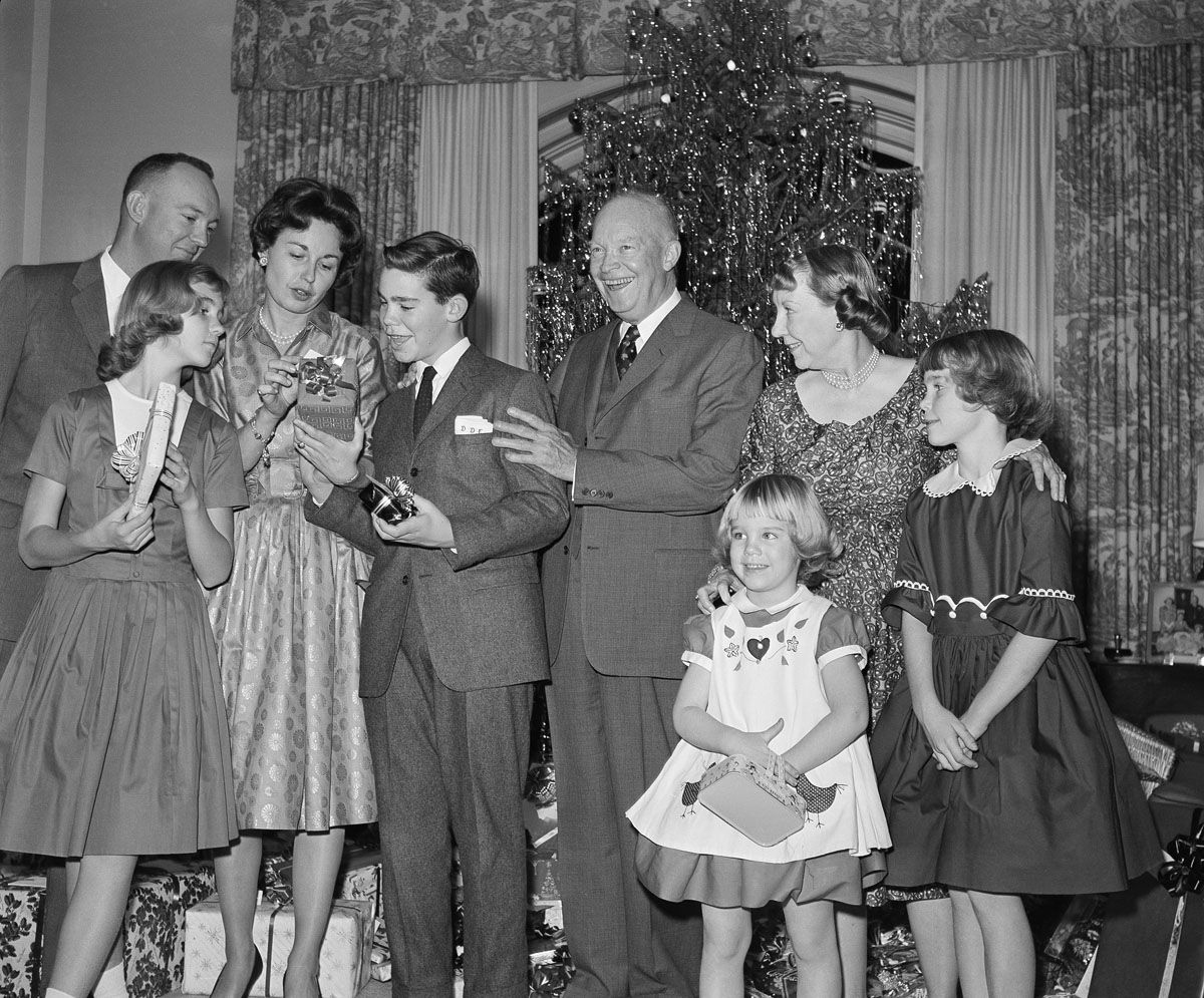 President Eisenhower poses with members of his family during a Christmas Eve picture taking session in the west sitting room of the second floor residence section of the White House in Washington on Dec. 24, 1960. From left: Lt. Col. John Eisenhower; Barbara Anne, 11, in front; Mrs. John Eisenhower, David 12, the President, Mrs. Eisenhower, Mary Jean, 5, in front, and Susan, 9. (AP Photo/Henry Griffin )