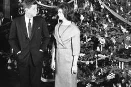 FILE - In this Dec. 13, 1961 file photo, President John F. Kennedy and his wife, Jacqueline, pose in front of the Christmas tree in the Blue Room of the White House in Washington. The occasion was a pre-Christmas party for White House staff members and their families. (AP Photo/Henry Burroughs)