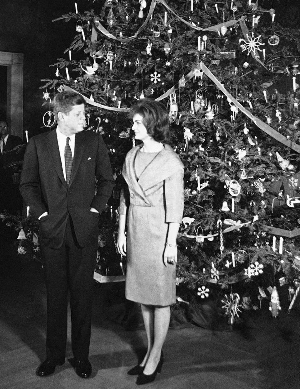 FILE - In this Dec. 13, 1961 file photo, President John F. Kennedy and his wife, Jacqueline, pose in front of the Christmas tree in the Blue Room of the White House in Washington. The occasion was a pre-Christmas party for White House staff members and their families. (AP Photo/Henry Burroughs)