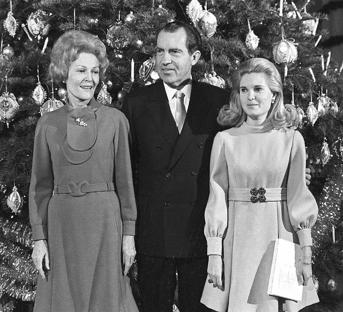 U.S. President Richard Nixon, first lady Pat Nixon and their daughter Tricia stand beside the Christmas tree in the main lobby of the White House on Dec. 21, 1969, following a worship service.   (AP Photo)