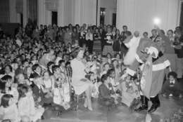 First Lady Betty Ford applauds as Santa Claus greets some of the children of diplomats during a Christmas party in the White House East Room in Washington Tuesday, Dec. 16, 1975. Approximately 500 children from 84 different countries attended the party hosted by Mrs. Ford. (AP Photo/PBR/Peter Bregg)