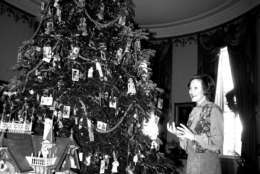 First Lady Rosalynn Carter stands beside the White House Christmas tree Tuesday, December 12, 1978,  during a preview for reporters.  The tree is decorated with antique toys, dolls, and miniature furniture from the collections of the Margaret Woodbury Strong Museum in Rochester, N.Y.  (AP Photo/Barry Thumma)