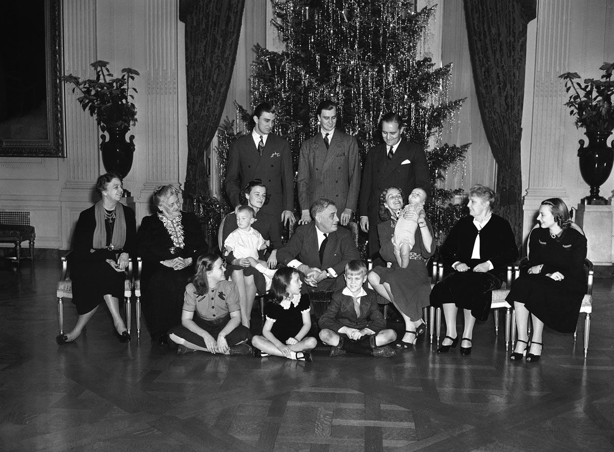 It was a family Christmas at White House (in Washington, D.C.) on Dec. 25, 1939 and above is the family portrait in the East Room.   In picture, the performing Johnny Boettiger, nine-month-old grand son of  President Franklin D. Roosevelt, is the cynosure of all eye seated, left to right: Mrs. Eleanor Roosevelt; Mrs. Sara Roosevelt,  president's mother; Mrs. Franklin Roosevelt, Jr., with Franklin III on lap; the president; Mrs. John Boettiger president's daughter Anna and her son, Johnny; Mrs. J.R. Roosevelt (President's sister-in-law); Mrs. Anne Roosevelt; wife of son John;  standing, Franklin, Jr. and John; John Boettiger on floor, Eleanor "Sistie" Dall; Diana Hopkins,  Commerce secretary's daughter; and Curtis "Bussie" Dall, Jr.        Only the families of Elliott and James were missing.  (AP Photo)