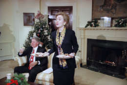 First lady Hillary Clinton offers cookies to the Arkansas press corps during an interview with President Bill Clinton in the Roosevelt Room at the White House, Washington, Dec. 22, 1993. (AP Photo/J. Scott Applewhite)