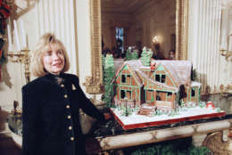 First Lady Hillary Rodham Clinton, standing next to a gingerbread house replica of President Clinton’s Hope, Ark., boyhood home, speaks to reporters during a tour of White House Christmas decorations in Washington  Monday, Dec. 5, 1994. Speaking about House Speaker-in-waiting Newt Gingrich’s comments on orphanages, Mrs. Clinton said she was seen the movie “Boys Town” and she still doesn’t like orphanages. (AP Photo/Wilfredo Lee)