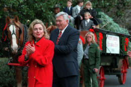 First lady Hillary Rodham Clinton arrives on the White House South Lawn to greet the First Family's Christmas tree Monday, Nov. 27, 1995 in Washington. Beside her is Ron Hudler, of West Jefferson, N.C., who presented this year's White House tree, an 18-1/2 foot Fraser fir from Ashe County, N.C. The tree will be displayed in the Blue Room. (AP Photo/Doug Mills)