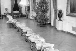 These packages, placed on benches in the East Room of the White House in Washington on Dec. 23, 1942, will be distributed by President and Mrs. Franklin Roosevelt to younger children of White House employees on Christmas Eve. The gifts all will go to children under 12. (AP Photo/George R. Skadding)
