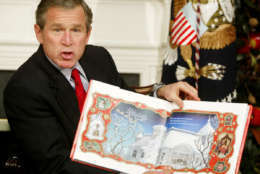 President Bush begins to read to area children as he participates in the White House children's story hour, Tuesday, Dec. 17, 2002, in the Roosevelt Room of the White House in Washington. Bush and the first lady read from " 'Twas the Night Before Christmas."  (AP Photo/Ron Edmonds)