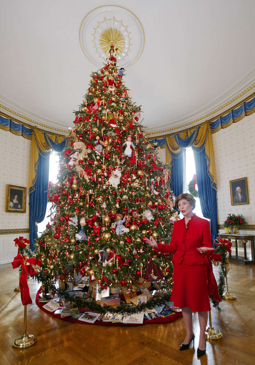 First lady Laura Bush presents the White House Christmas tree in the Blue Room during a preview of the White House holiday decorations Thursday, Dec. 4, 2003, in Washington. The eighteen and a half foot Fraser fir came from Wisconsin.   (AP Photo/Manuel Balce Ceneta)