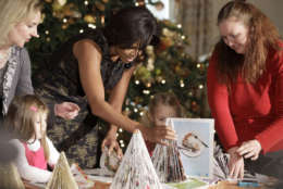 First lady Michelle Obama makes Christmas arts and crafts with children from military families, Wednesday, Dec. 1, 2010, in the State Dining Room of the White House in Washington. (AP Photo/Charles Dharapak)