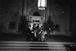 President Dwight Eisenhower and first lady Mamie Eisenhower pose with their family on the Christmas tree-lighted North Portico of the White House in Washington,  Dec. 19, 1958.  The grandchildren, left to right, are: Barbara Ann, 9; Mary Jean, 8; David, 19, and Susan, 7; Maj. John Eisenhower and his wife Barbara Jean stand in the rear.  (AP Photo/Bill Allen)