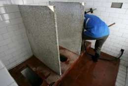 A worker cleans a public toilet in Beijing on World Toilet Day 2004, Friday Nov. 19, 2004. Beijing has been hosting the World Toilet Summit this week, a three-day international commode conference with a mission: the globalization of presentable latrines. China, known for fetid public toilets that often are little more than open trenches, has been eager to show off its advances while preparing for the 2008 Beijing Olympics. (AP Photo/Greg Baker)