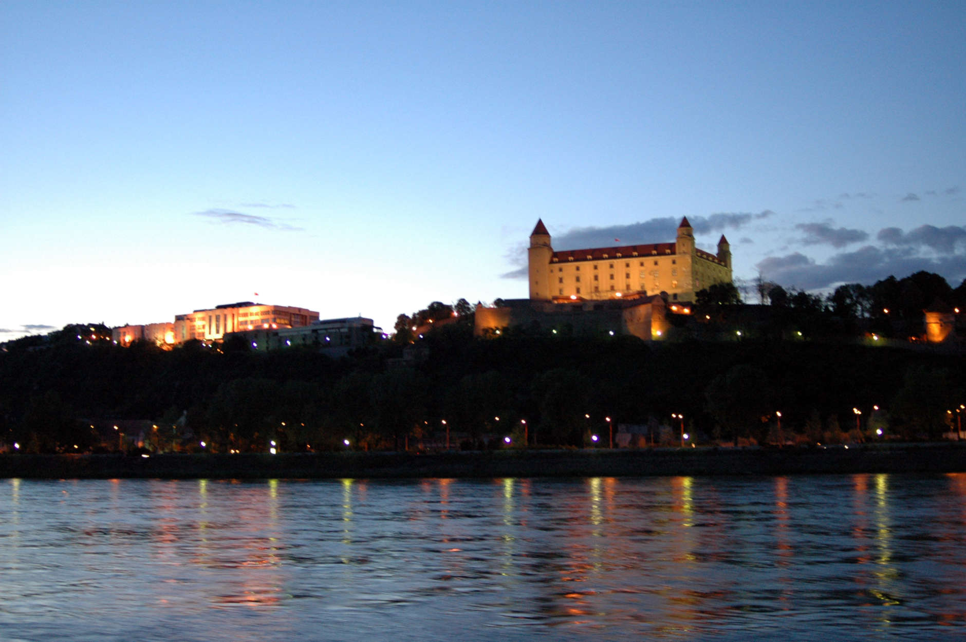 ** FILE ** The Bratislava castle is illuminated above river Danube in this May 8, 2005 file photo. The house of Slovak parliament can be seen at left. (AP Photo/Jan Koller, CTK)
