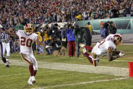 Washington Redskins safety Sean Taylor (21) leaps for a touchdown after his 39-yard fumble-return against the Philadelphia Eagles in the fourth quarter of their NFL football game Sunday, Jan. 1, 2006, in Philadelphia. At left is safety Pierson Prioleau (20). The Redskins won, 31-20. (AP Photo/Tom Mihalek)