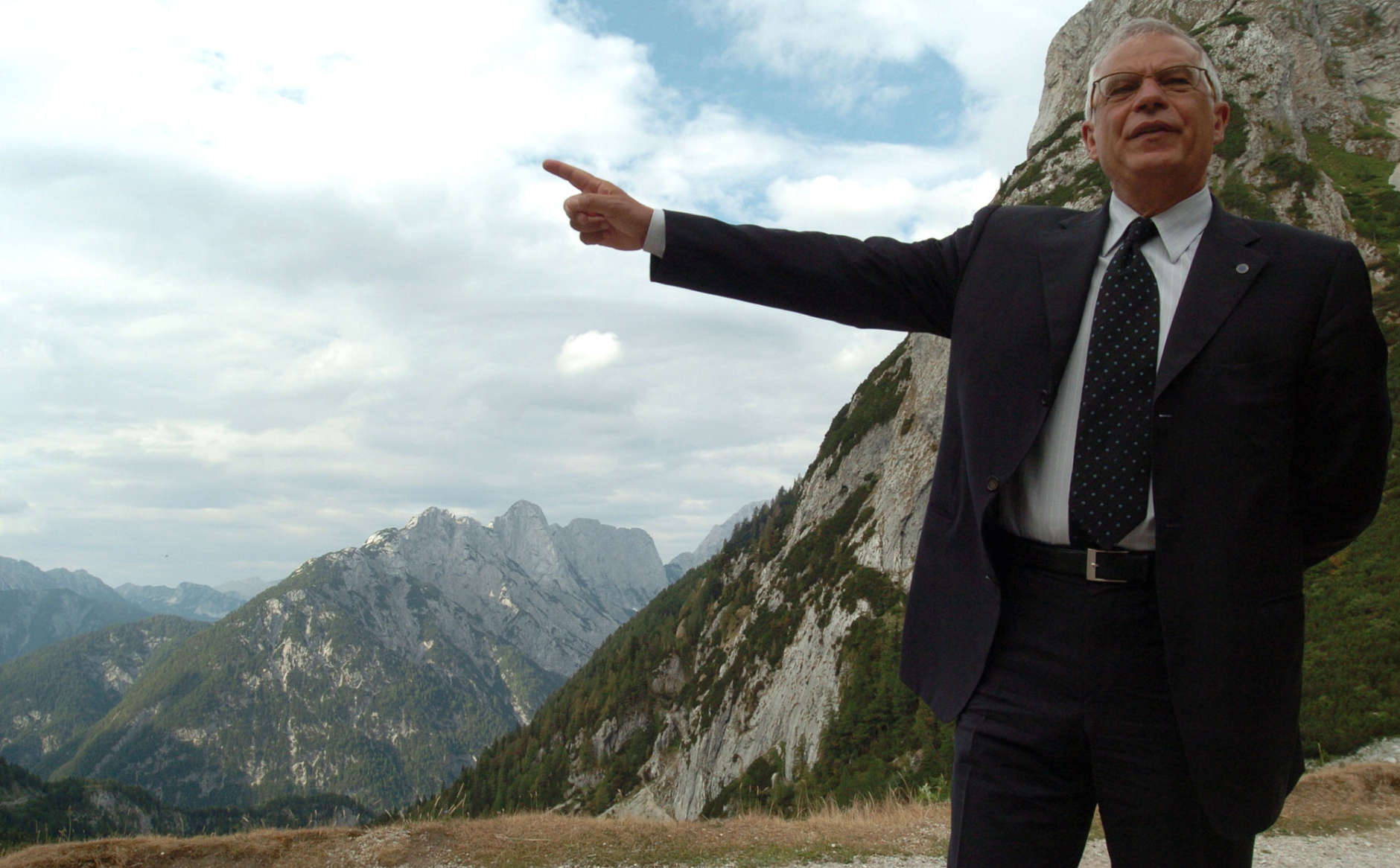 President of the European Parliament Josep Borrell points the highest mountain of Slovenia, Triglav, 2864 meters (9,396 feet) high, before attending the 90th anniversary of the Russian chapel built by the Russian prisoners in 1916 on the mountain road over the Vrsic pass, Slovenia, around 55 miles (88 km) north-west of Ljubljana, Sunday, July 30, 2006. (AP Photo/Denis Sarkic)