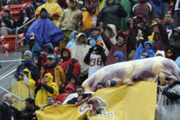 A sign bearing the name of the late Washington Redskins' Sean Taylor is revealed in a ceremony prior to the Redskins' NFL football game against the New York Giants in Landover, Md., Sunday, Nov. 30, 2008. Taylor, who was fatally shot in his Florida home a year ago,  was inducted into the Redskins Ring of Fame. (AP Photo/Susan Walsh)