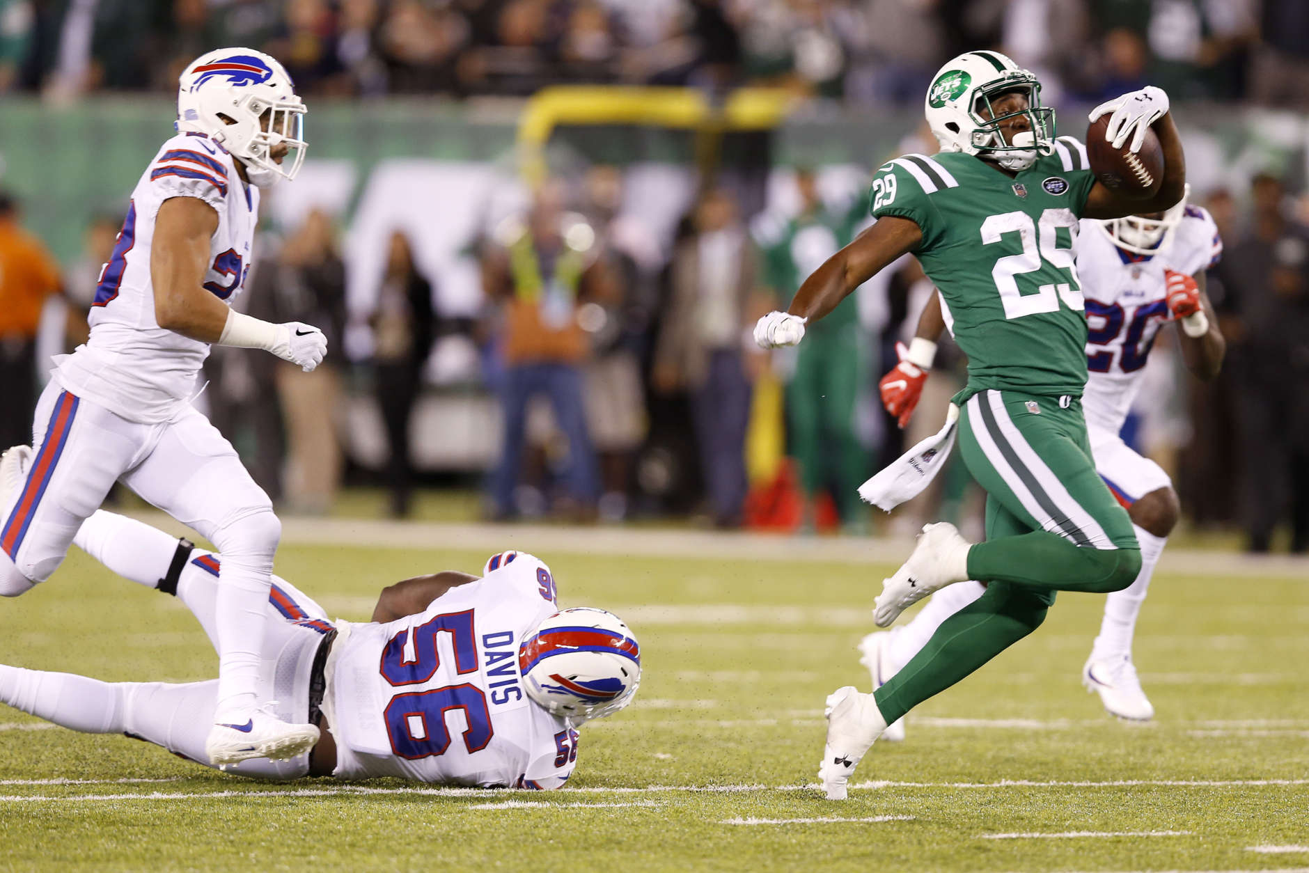 New York Jets running back Bilal Powell, right, avoids being tripped up by Buffalo Bills defensive end Ryan Davis (56) on a long run during the second half of an NFL football game, Thursday, Nov. 2, 2017, in East Rutherford, N.J. (AP Photo/Kathy Willens)