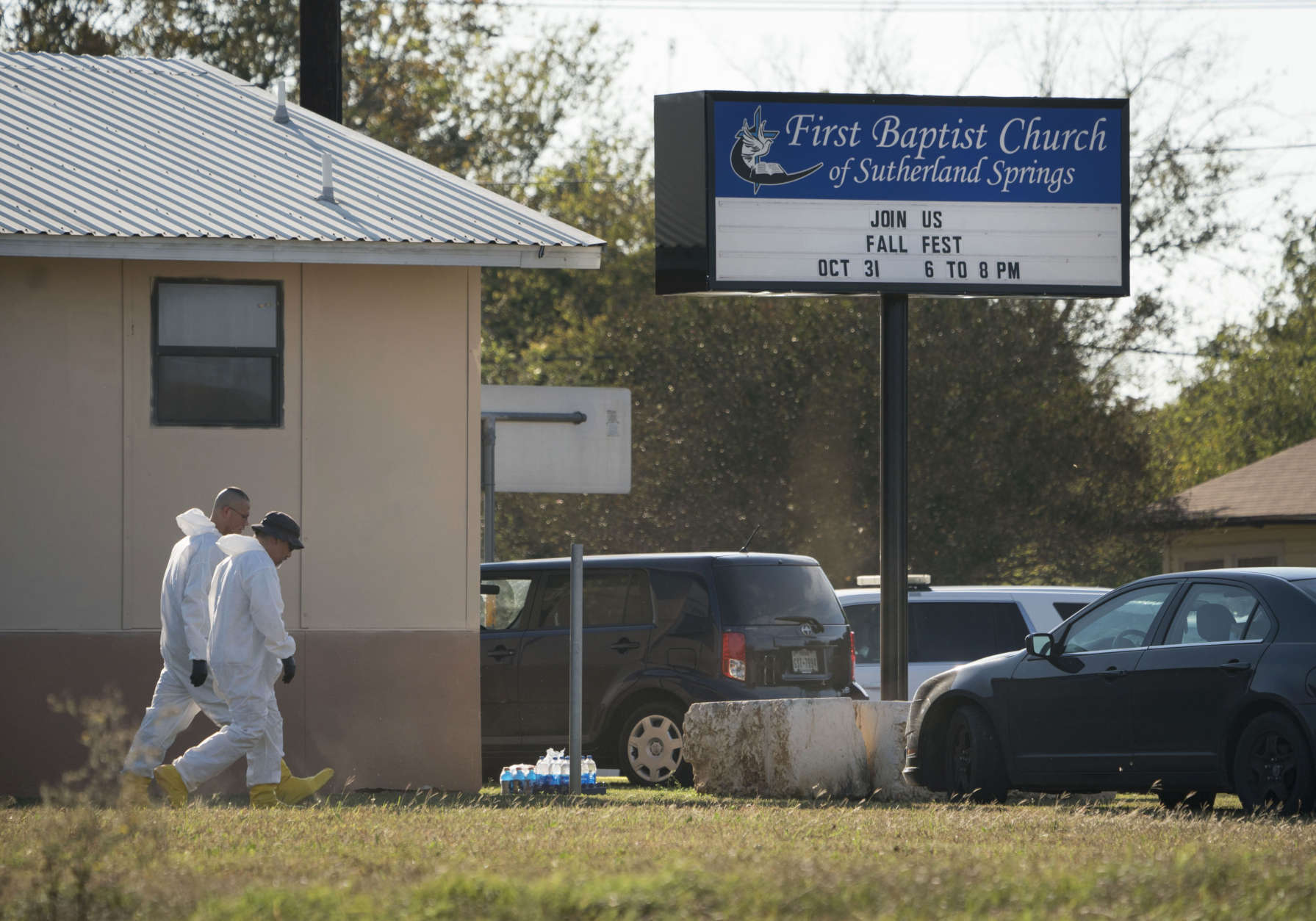 Members of the FBI walk next to the First Baptist Church of Sutherland Springs after a fatal shooting, Sunday, Nov. 5, 2017, in Sutherland Springs, Texas. (AP Photo/Darren Abate)